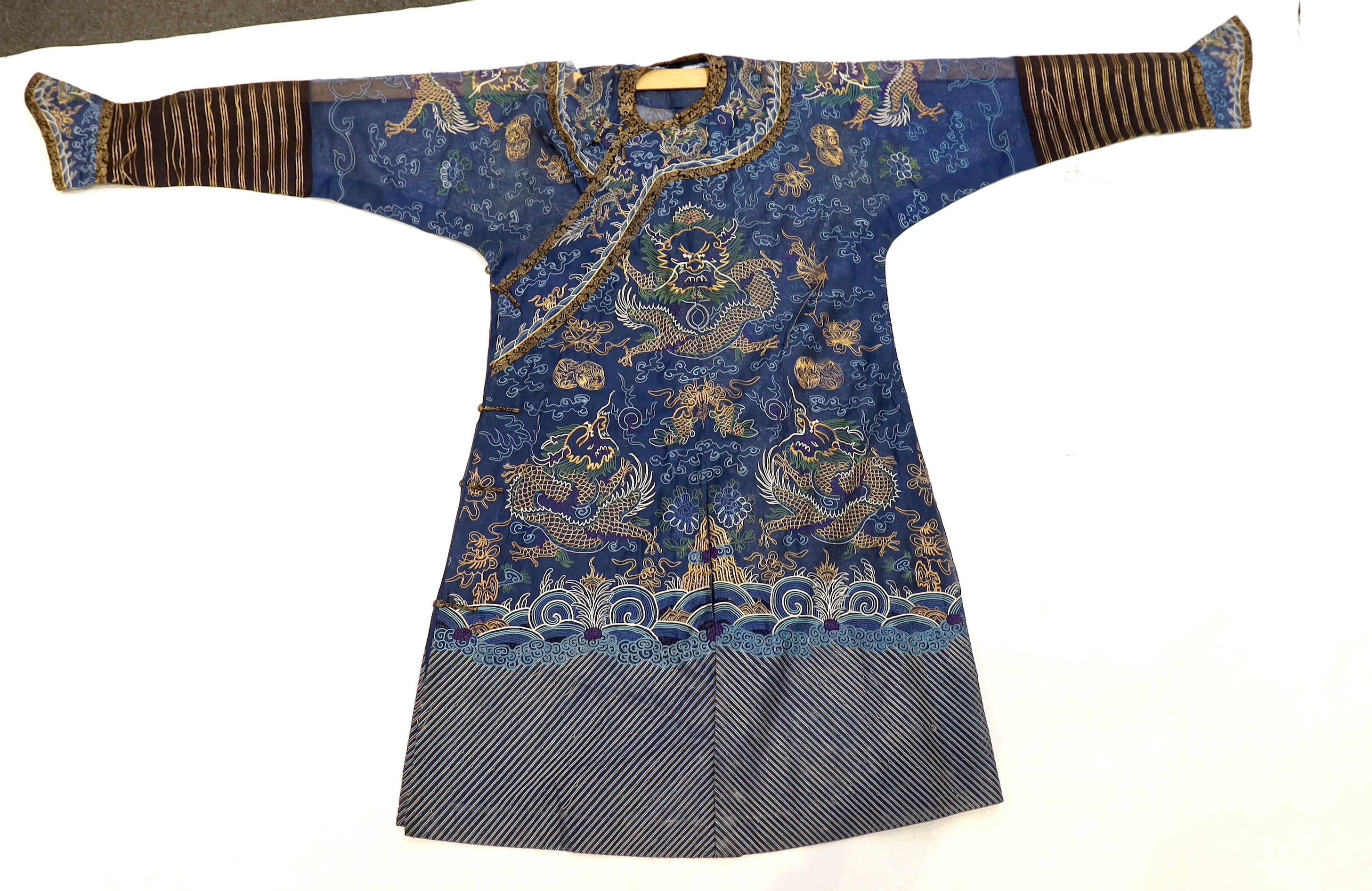 A Chinese fine blue gauze summer robe embroidered with a gold thread dragon highlighted by coloured silk embroidery together with a similar gauze panel embroidered with dragons, 163cm x 75cm